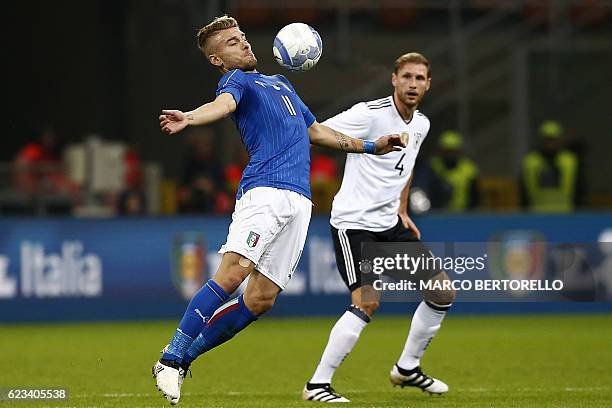 Italy's forward Ciro Immobile controls the ball next to Germany's defender Benedikt Hoewedes durig the International friendly football match Italy vs...