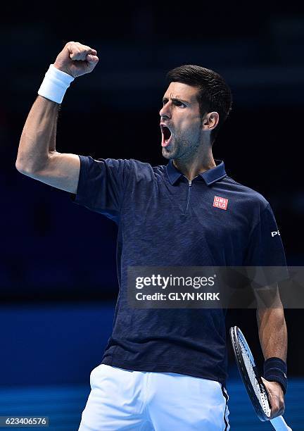 Serbia's Novak Djokovic reacts after taking a 6-5 lead in a first set tie-break against Canada's Milos Raonic during their round robin stage men's...