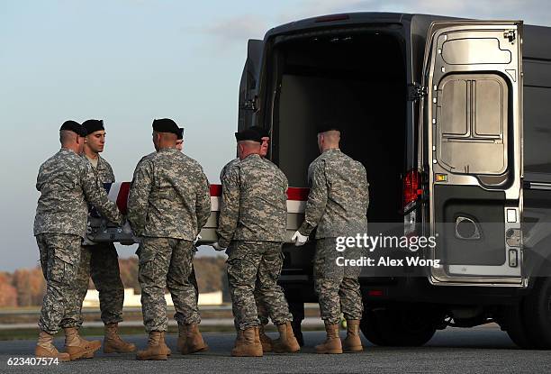 Members of a U.S. Army carry team move the flag-draped transfer case holding the remains of Army Pfc. Tyler R. Iubelt of Tamaroa, Illinois, into a...