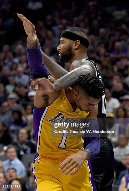 Angelo Russell of the Los Angeles Lakers gets tangled up with DeMarcus Cousins of the Sacramento Kings during an NBA basketball game at Golden 1...