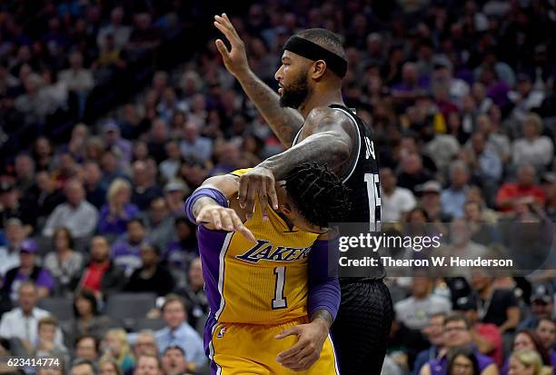 Angelo Russell of the Los Angeles Lakers gets tangled up with DeMarcus Cousins of the Sacramento Kings during an NBA basketball game at Golden 1...