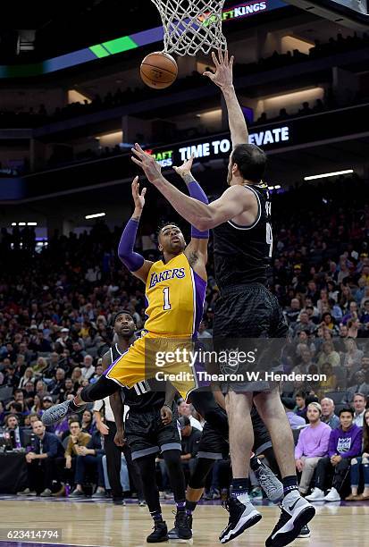 Angelo Russell of the Los Angeles Lakers shoots over Kosta Koufos of the Sacramento Kings during an NBA basketball game at Golden 1 Center on...