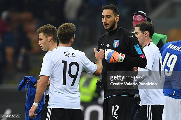 Gianluigi Donnarumma of Italy and Mario Gotze of Germany during the International Friendly Match between Italy and Germany at Giuseppe Meazza Stadium...