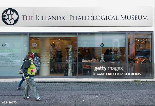 People walk outside the Icelandic Phallological Museum in Reykjavik on October 27, 2016. Inside the museum's large illuminated rooms, there are...