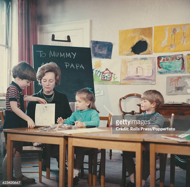 Members of the British Royal Family, Lady Sarah Armstrong-Jones and Prince Edward pictured together with a teacher and fellow pupil at nursery school...