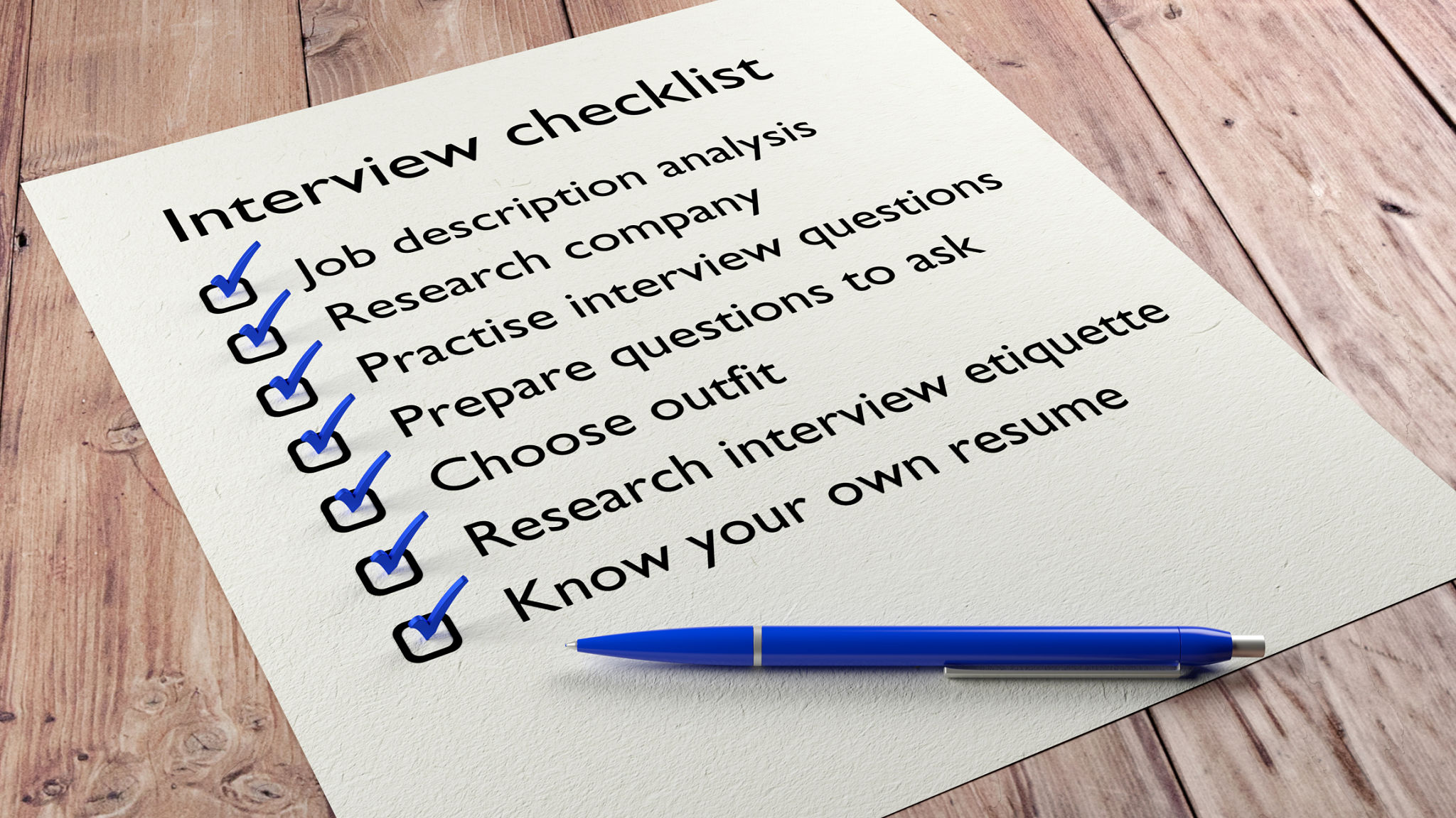 Interview checklist blue pen on wooden table Interview checklist blue pen on wooden table