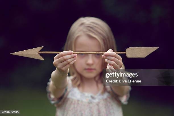 girl holding wooden arrow - frank wood stock pictures, royalty-free photos & images