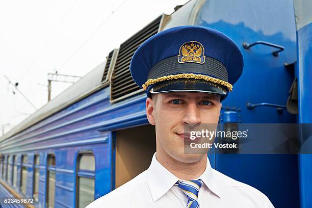 portrait of a train conductor - lokführer stock-fotos und bilder