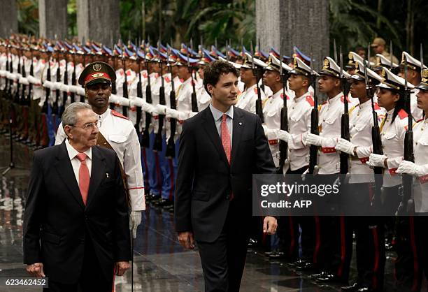 Canada's Prime Minister Justin Trudeau and Cuban President Raul Castro review the guard of honour during a ceremony at Revolution Palace on November...
