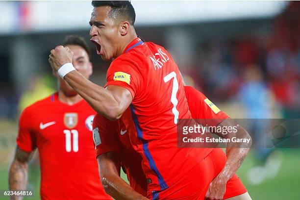 Alexis Sanchez of Chile celebrates with teammates after scoring the second goal of his team during a match between Chile and Uruguay as a part of...
