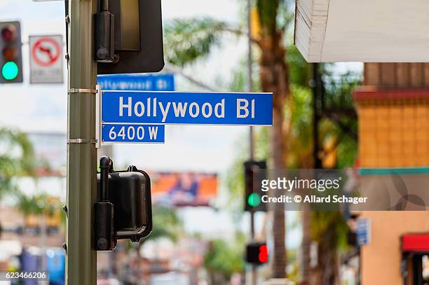 hollywood boulevard road sign in los angeles - hollywood california fotografías e imágenes de stock