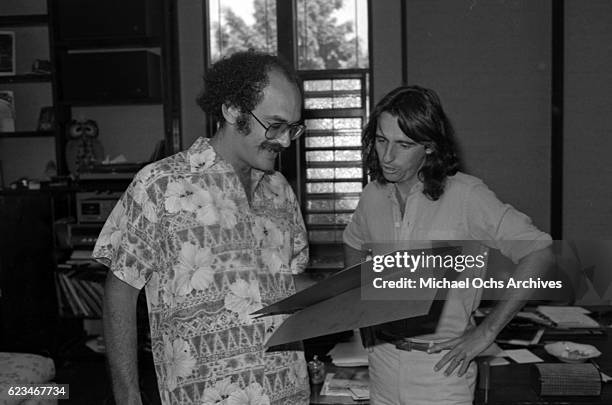 Manager Shep Gordon and musician Alice Cooper hold a check made out to the Hollywood Chamber of Commerce to buy the "O" in the Hollywood sign in...