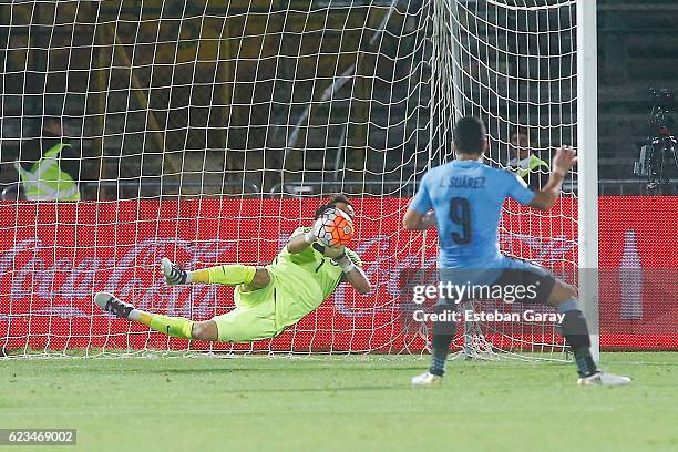 Claudio Bravo goalkeeper of Chile dives to stop the ball during a match between Chile and Uruguay as part of FIFA 2018 World Cup Qualifiers at...