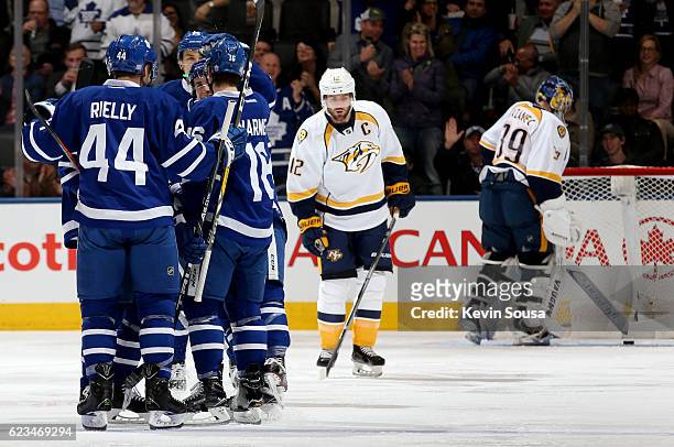Mitchell Marner of the Toronto Maple Leafs is congratulated on his goal as Mike Fisher of the Nashville Predators skates away and Nashville Predators...