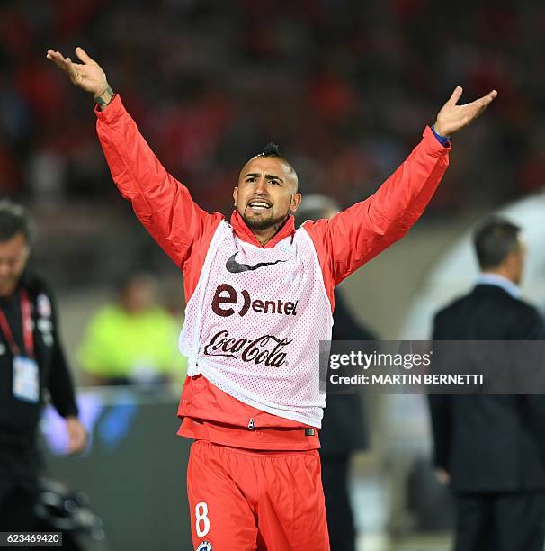 Chile's midfielder Arturo Vidal celebrates after defeating Uruguay in a 2018 FIFA World Cup qualifier football match in Santiago, on November 15,...