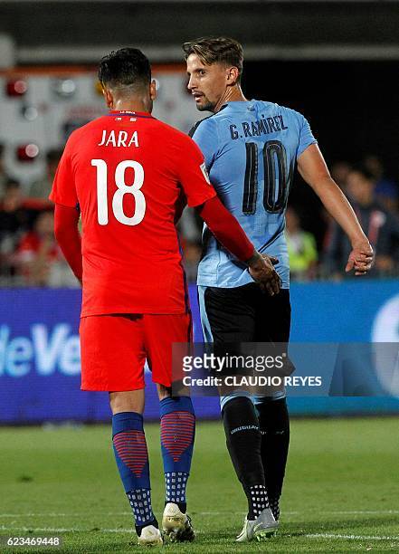 Chile's Gonzalo Jara and Uruguay's Gaston Ramirez during their 2018 FIFA World Cup qualifier football match in Santiago, on November 15, 2016. / AFP...
