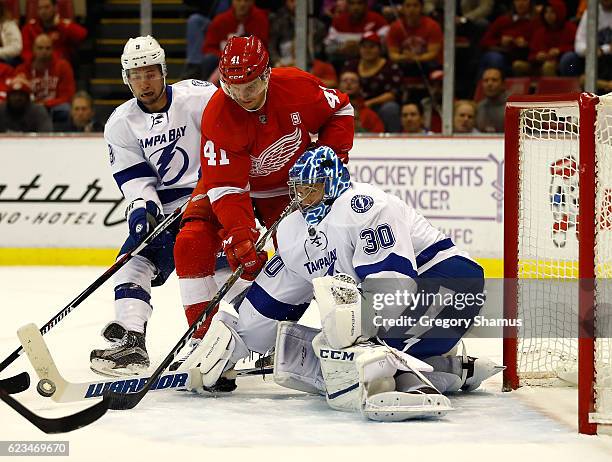 Ben Bishop of the Tampa Bay Lightning makes a first period save on the Luke Glendening of the Detroit Red Wings at Joe Louis Arena on November 15,...