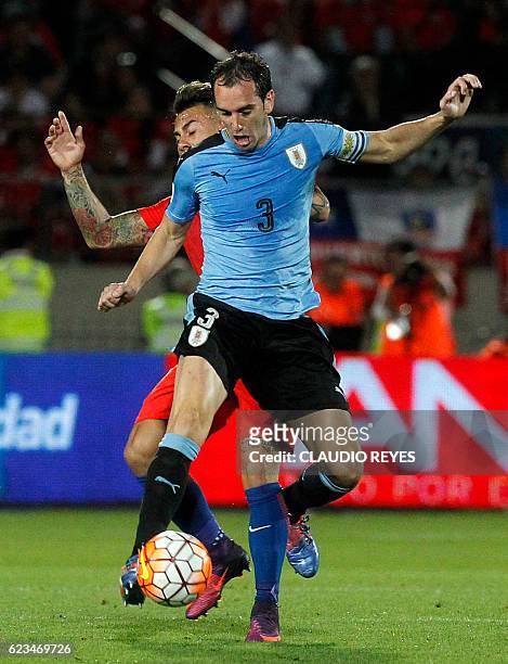 Uruguay's Diego Godin and Chile's forward Eduardo Vargas vie for the ball during their 2018 FIFA World Cup qualifier football match in Santiago, on...