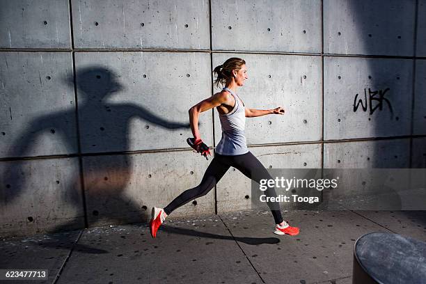 female running at night - evening walk stock pictures, royalty-free photos & images