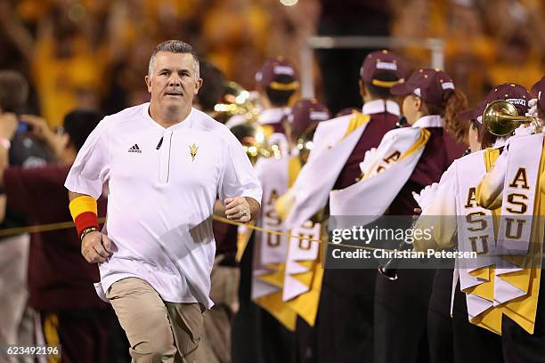 Head coach Todd Graham of the Arizona State Sun Devils runs onto the field before the college football game against the Washington State Cougars at...