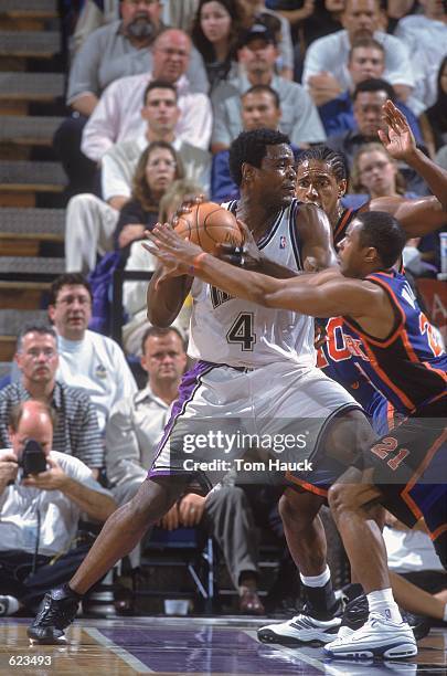 Chris Webber of the Sacramento Kings looks to pas the ball as he is double teammed during the game against the New York Knicks at the Arco Arena in...