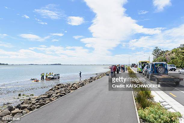 General view as emergency services try to get an injured man out of his car at the scene where a man crashed his car into the sea on November 16,...