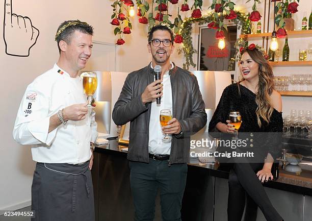 Belgian Chef Bart Vandaele, Stella Artois Vice President Harry Lewis, and Chrissy Teigen toast to a season of extraordinary hosting at Stella Artois'...