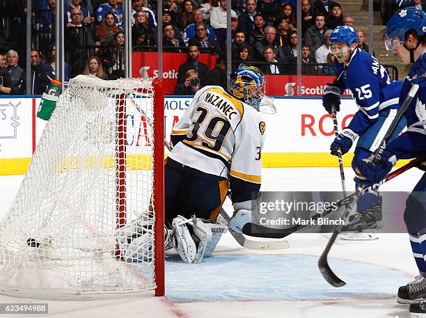 James van Riemsdyk of the Toronto Maple Leafs scores his third goal of the game on Nashville Predators goalie Marek Mazanec during the third period...