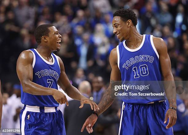 Kyle Lowry of the Toronto Raptors shares a laugh with DeMar DeRozan during NBA game action against the New York Knicks at Air Canada Centre on...