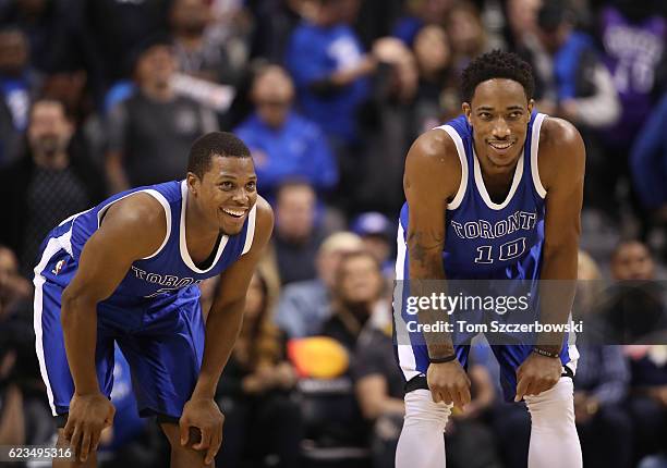 Kyle Lowry of the Toronto Raptors shares a laugh with DeMar DeRozan during NBA game action against the New York Knicks at Air Canada Centre on...