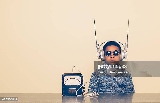 young boy dressed as nerd with alien headphones - intellectual ventures stock pictures, royalty-free photos & images