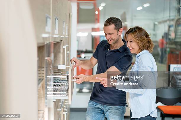 couple remodeling their house - furniture store stockfoto's en -beelden