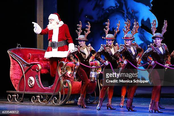 Santa and The Rockettes perform on stage during the "Christmas Spectacular Starring The Radio City Rockettes" Opening Night at Radio City Music Hall...