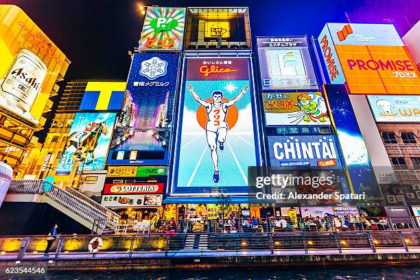 neon ads in dotonbori district, osaka, kansai region, japan - osaka - fotografias e filmes do acervo