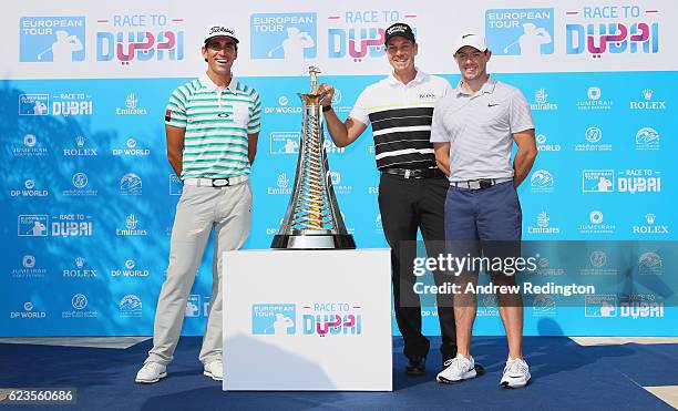 Rafa Cabrera Bello of Spain, Henrik Stenson of Sweden and Rory McIlroy of Northern Ireland stand in front of the new Race to Dubai brand, featuring...