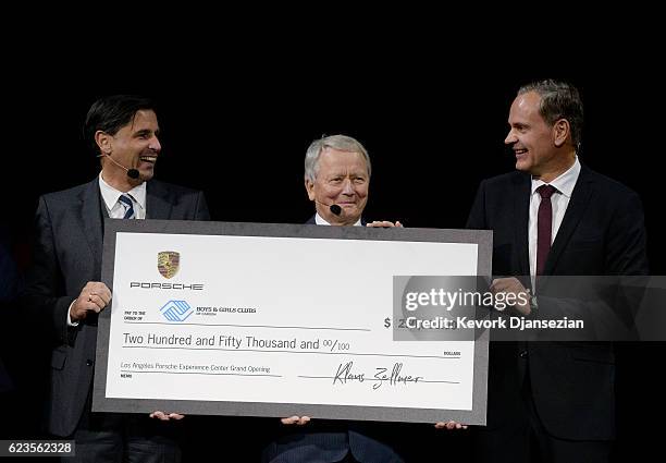 From left to right, Klaus Zellmer, Dr. Wolfgang Porsche and Oliver Blume present the donation to The Boys & Girls Clubs of Carson at the opening of...