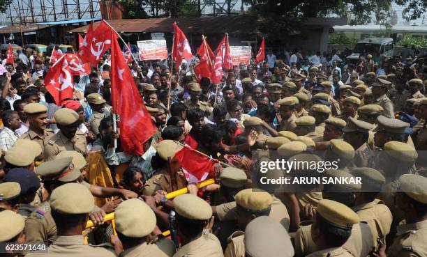 Indian police try to maintain control at a protest by members of the Communist Party of India against Indian Prime Minister Narendra Modi and the...