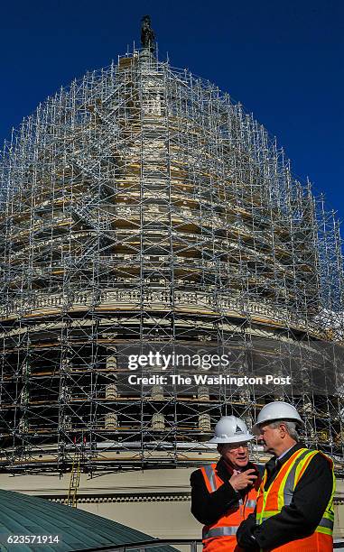 Sen. John Hoeven, right, and Stephen Ayers, the Architect of the Capitol, chat during a briefing to assembled press on the progress of the U.S....