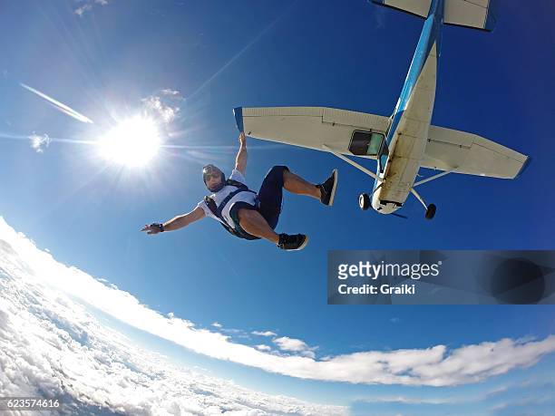 skydiver jump from the small plane - パラシュート ストックフォトと画像