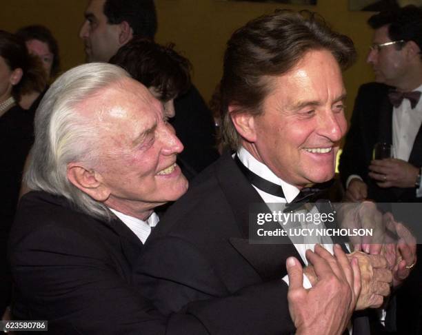 Actor Kirk Douglas hugs his son, actor/producer Michael Douglas, as they arrive at the Simon Wiesenthal Center Museum of Tolerance National Tribute...