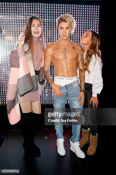 Youtuber Kassii and youtuber Nona pose with the Justin Bieber wax figure during the unveiling of the Justin Bieber wax figure at Madame Tussauds on...