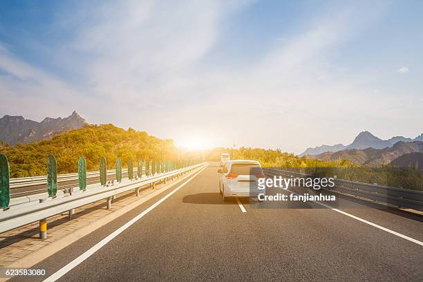 clouds float above a highway - long journey stock pictures, royalty-free photos & images