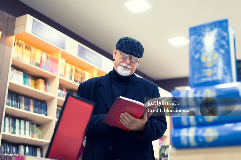 Man Reading Book In Bookstore