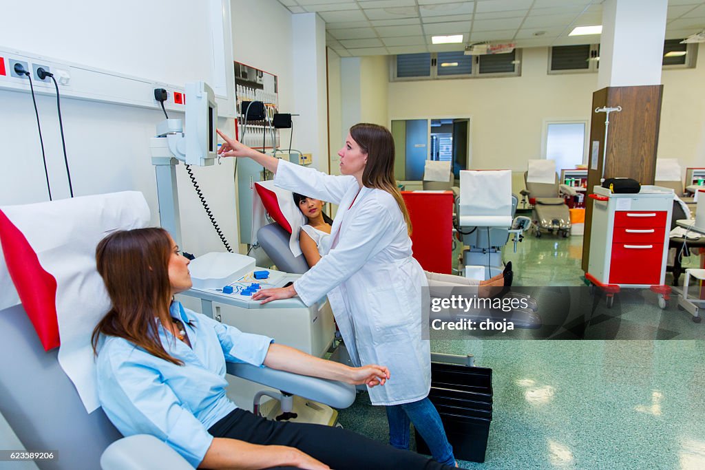 Young women are going to donate blood in  blood bank