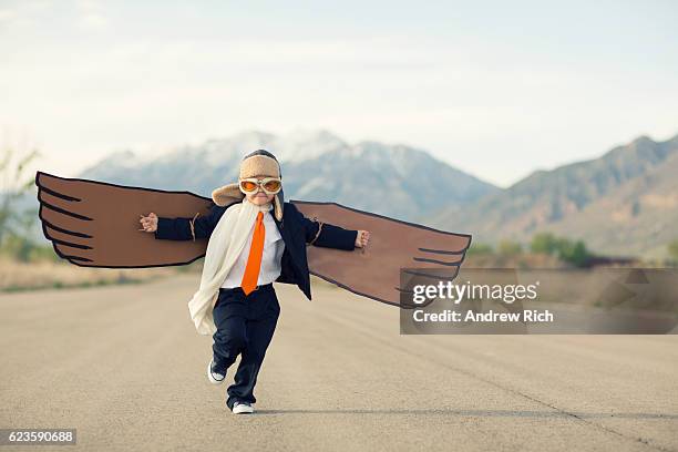 young boy businessman dressed in suit with cardboard wings - kid chef stockfoto's en -beelden
