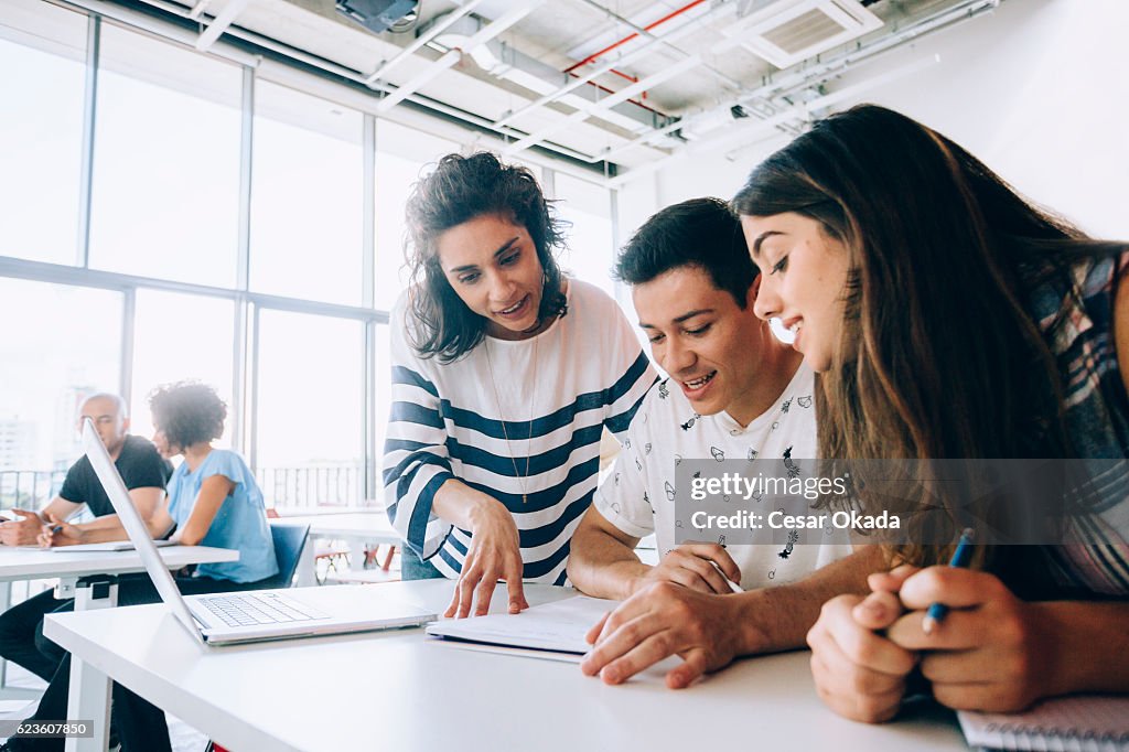 Teacher helping students