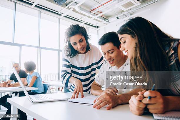 teacher helping students - demonstration stock pictures, royalty-free photos & images
