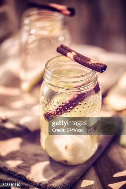 infused water with fresh pears and cinnamon - cinnamon stock pictures, royalty-free photos & images