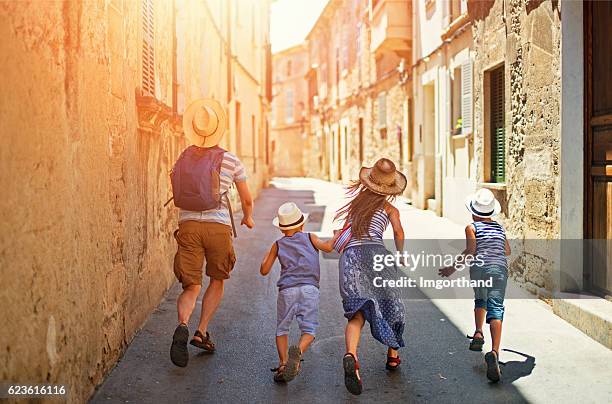 family visiting mediterranean town on majorca - alcudia stockfoto's en -beelden