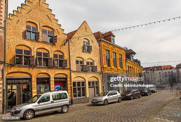 traditional old buildings by street at lille france - lille cafe stock pictures, royalty-free photos & images